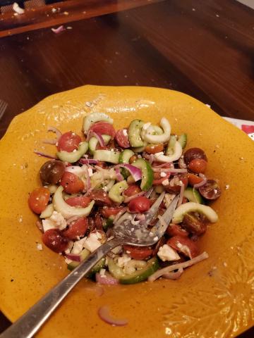 summer salad with cherry tomatoes, cucumbers, red onion, and feta cheese